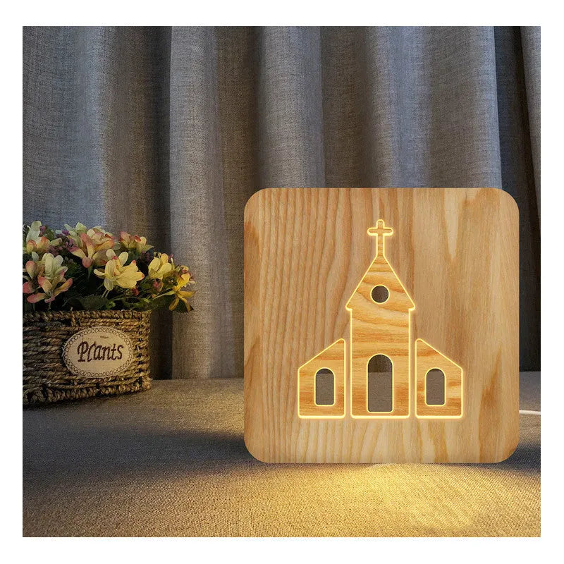 Solid wood hollow night lamp with warm white LED light, USB cable, and button switch on a wooden table