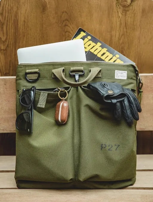 Canvas messenger bag in military green with shoulder strap and laptop compartment