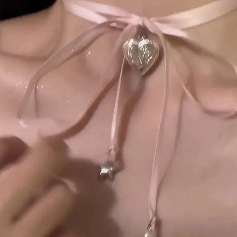 Women's alloy ribbon love pendant fashion necklace on a clavicle chain, available in 33 colours.