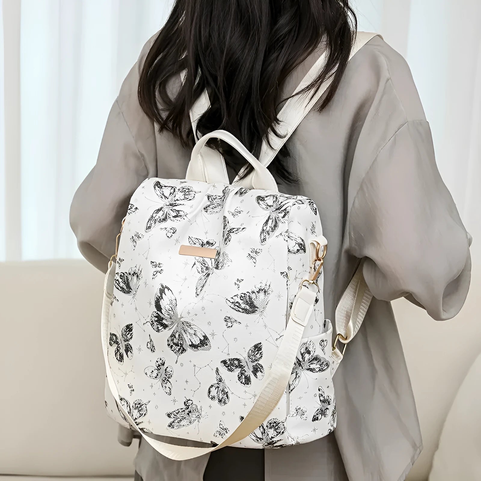 Butterfly printed PU shoulder backpack in black with sewing line details and 20L capacity
