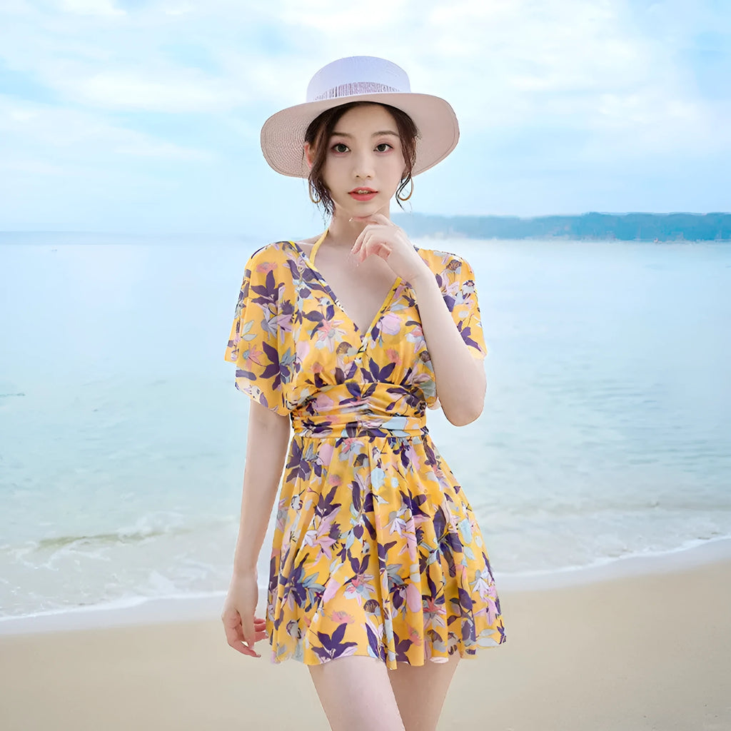 Women's yellow floral one-piece swimsuit made from polyester with full coverage design
