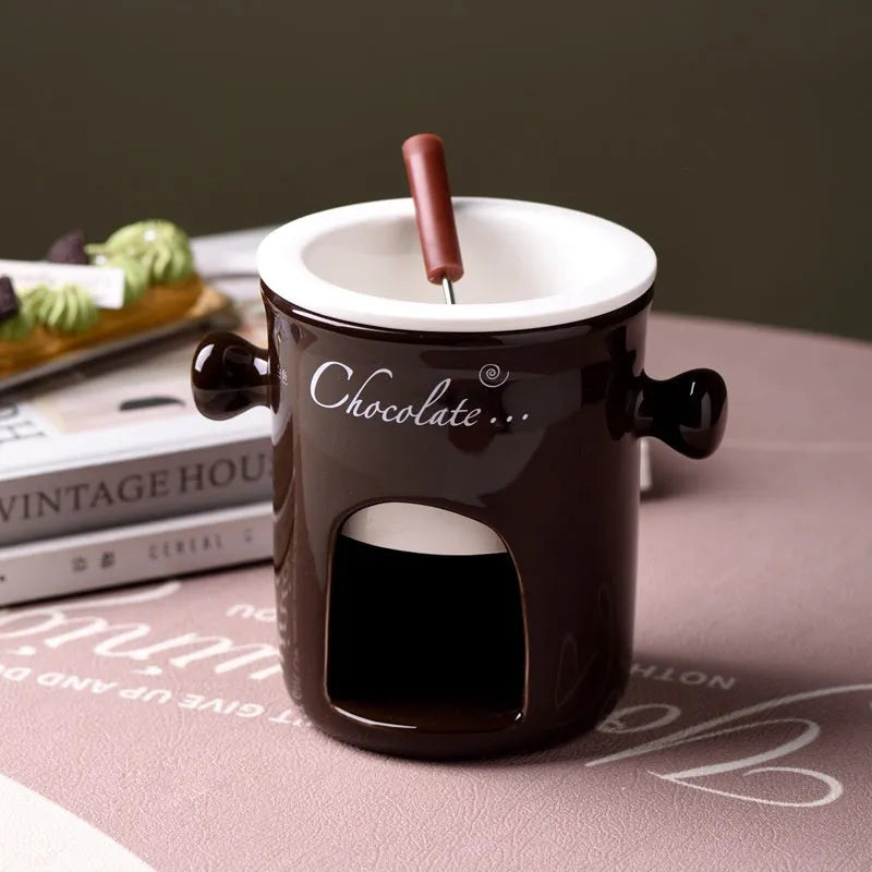 Ceramic binaural hot pot cup in brown for melting chocolate with fork and candle beside it