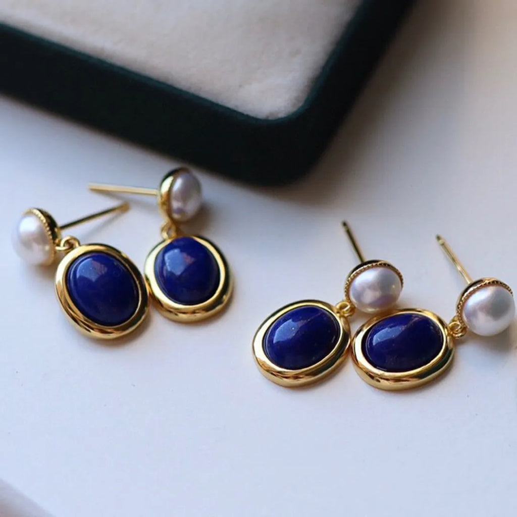 A pair of simple 925 silver earrings with blue lapis lazuli pearls and auspicious patterns.