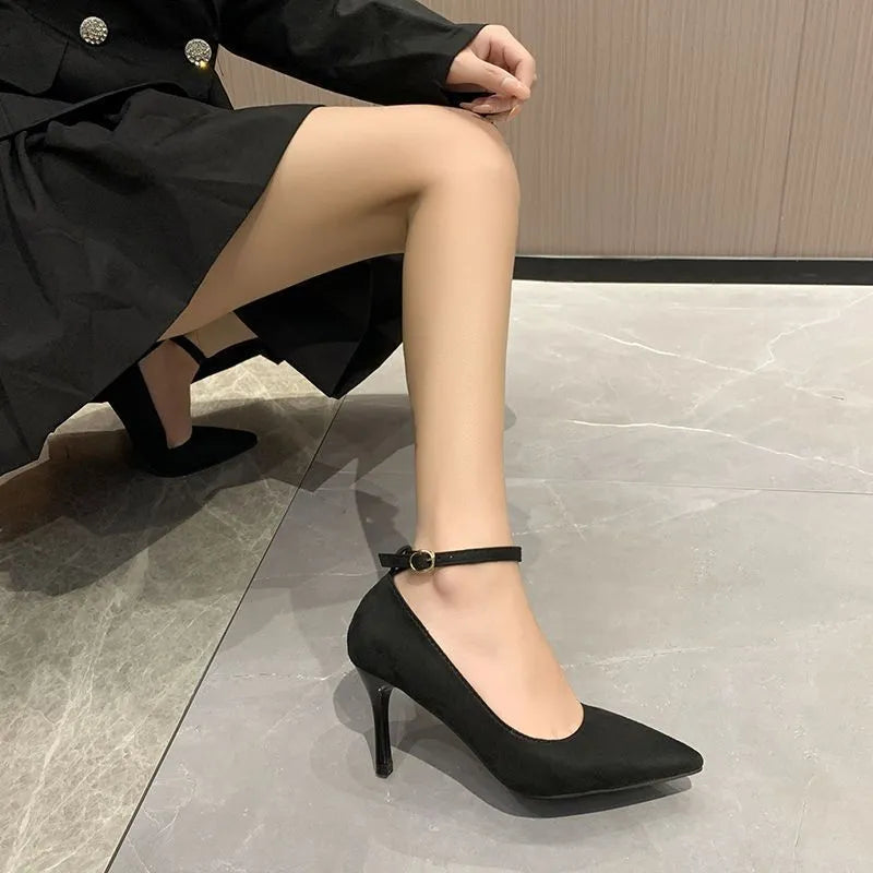 Women's black stiletto heel pump shoes with a buckle detail on the upper.