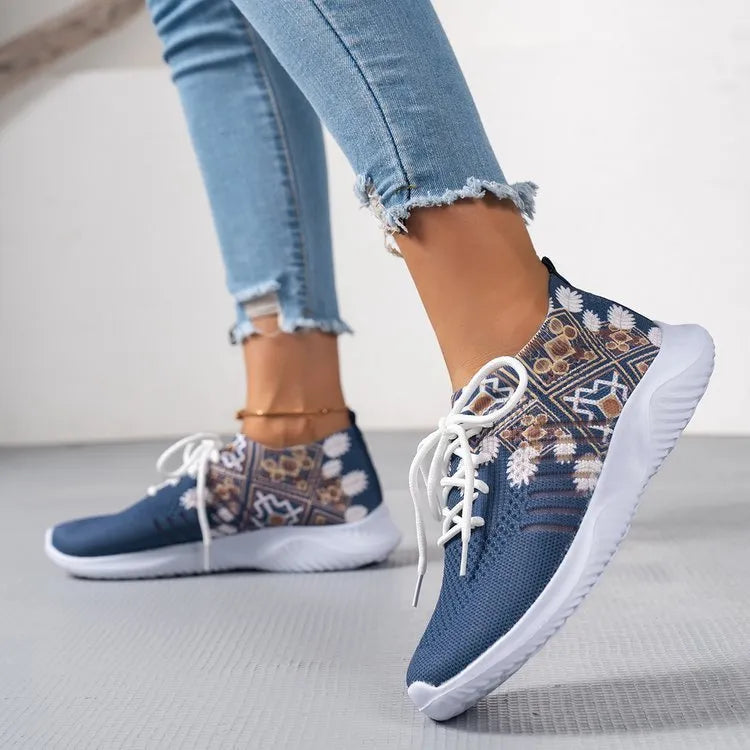Women's woven flat shoes in green with printed totem detail, mesh upper, rubber sole, and front lace-up closure