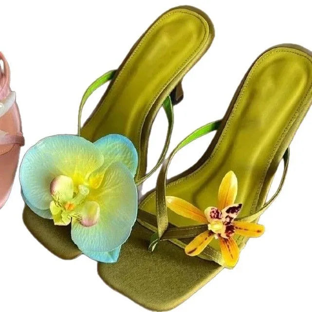Handmade women's high heel semi-slipper sandals with asymmetric flower detail, calf leather upper, square toe, and EVA sole in black, green, pink, and white