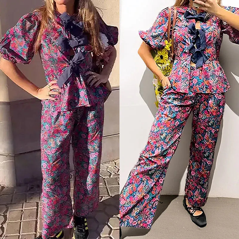 Women's floral printed trousers suit with tie-neck top featuring puff sleeves and matching trousers