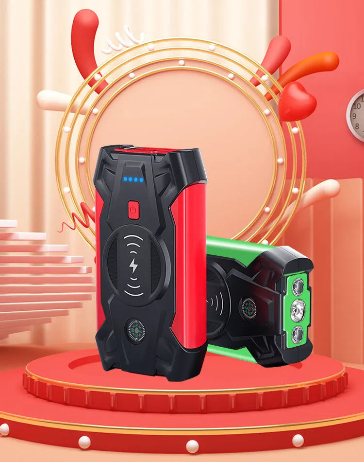 Compact red car battery jump starter unit with cables and clips on a dark background.
