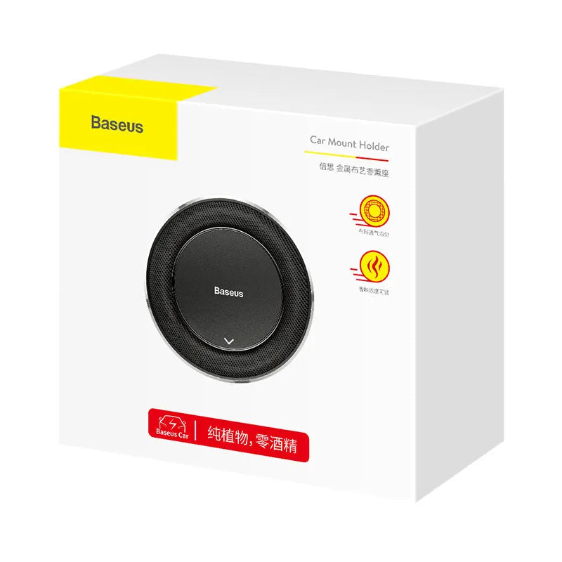Black aluminium alloy round car fragrance seat with aromatherapy tablets on a car dashboard.