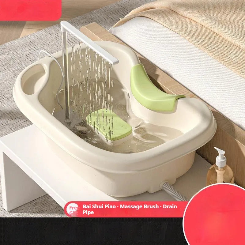 Portable plastic bed shampoo basin set with head pillow, water pump, and accessories in light pink colour.