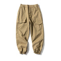 Solid colour cotton tapered casual pants with ankle ties, loose fit, available in black and khaki.