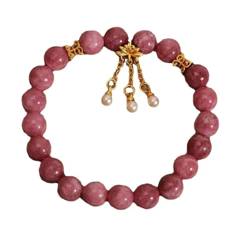 Natural stone beaded bracelet with pink lotus tassel and pearl pendant on white background