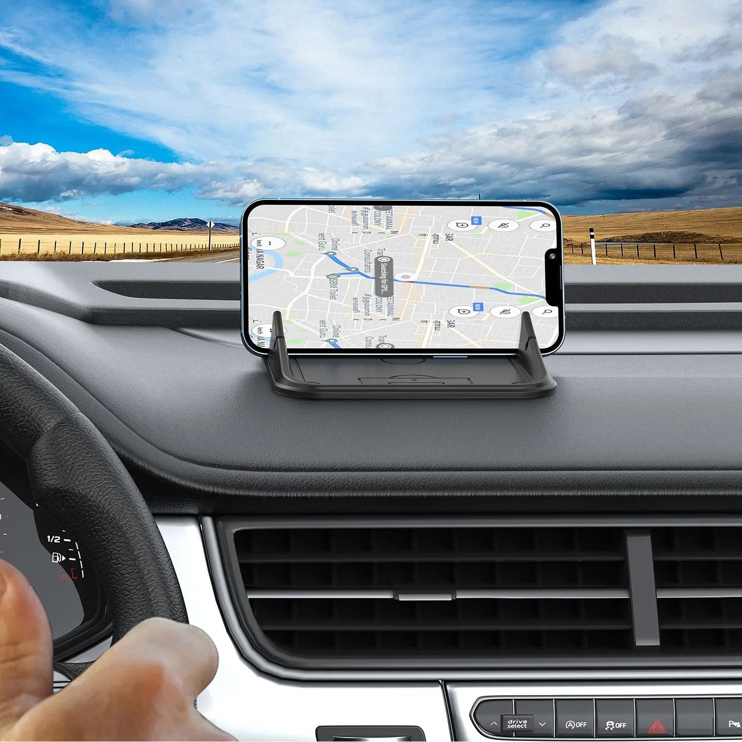 Grey silicone car phone holder Peak-X5 on dashboard with mobile phone inserted