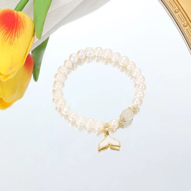 Natural freshwater pearl fishtail bracelet for women, handmade original design on display