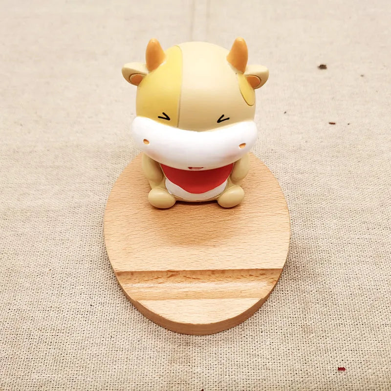 Beech wood mobile phone holder with resin animal design and coin slot