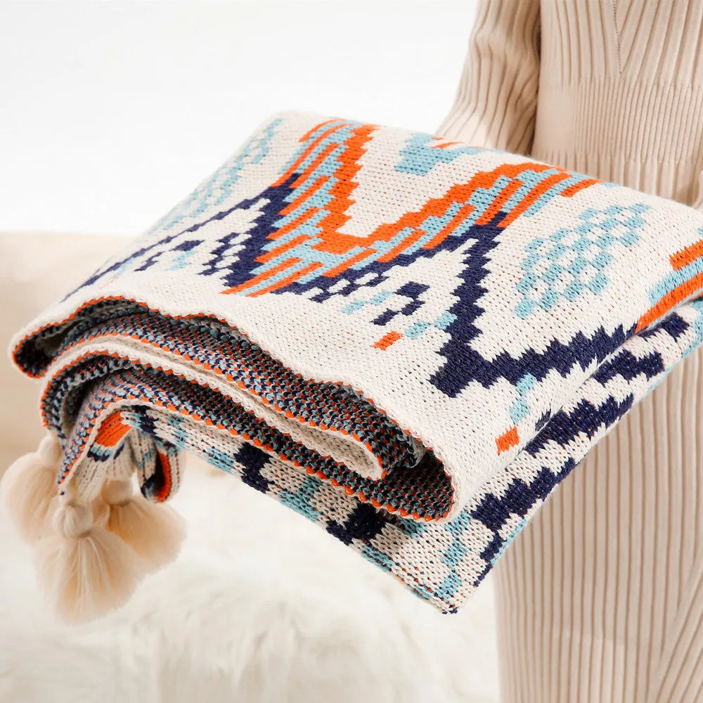 Bohemian style acrylic sofa throw blanket with tassel trim in a geometric pattern colour