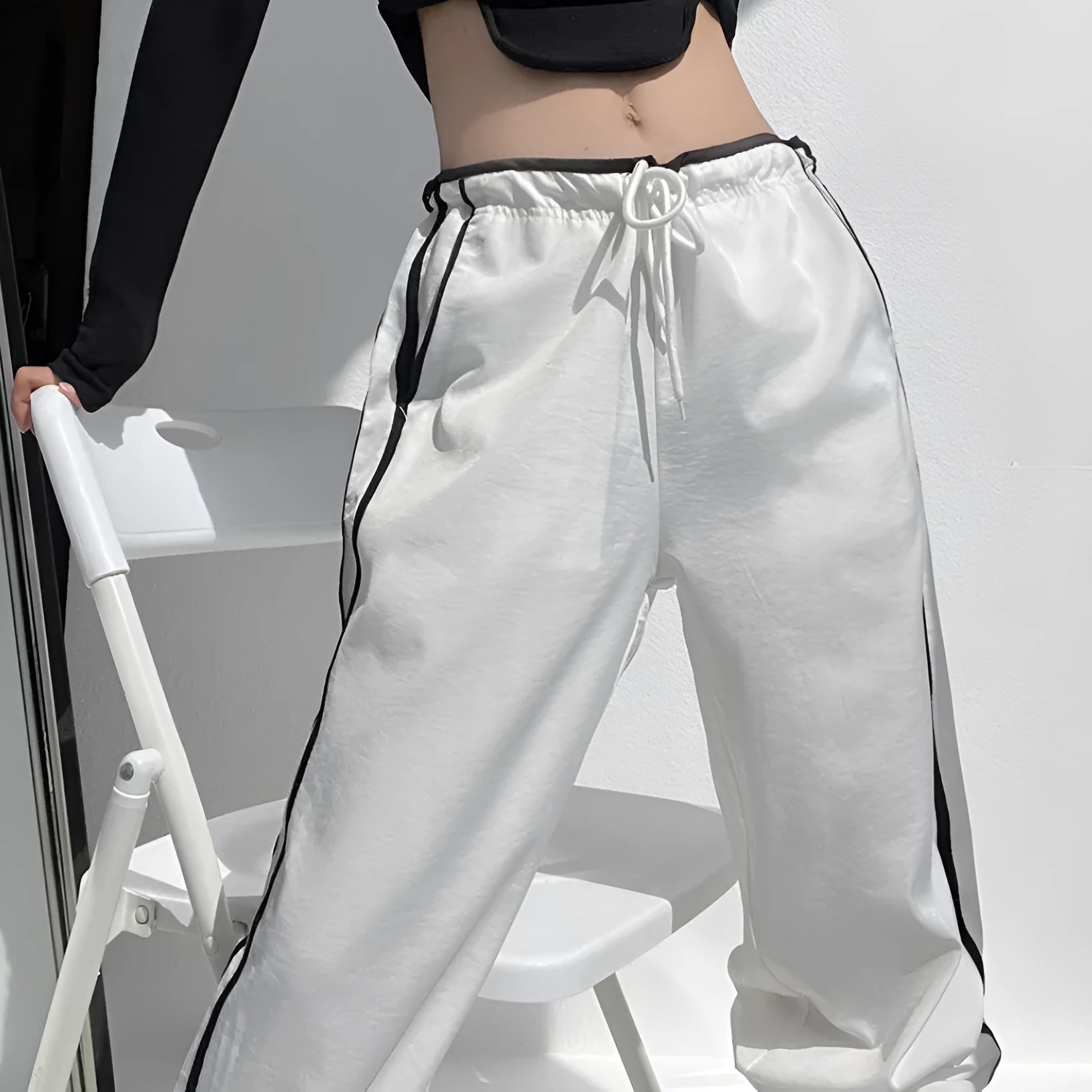 Women's navy blue parallel bars contrast colour loose straight leg trousers on a low waist.