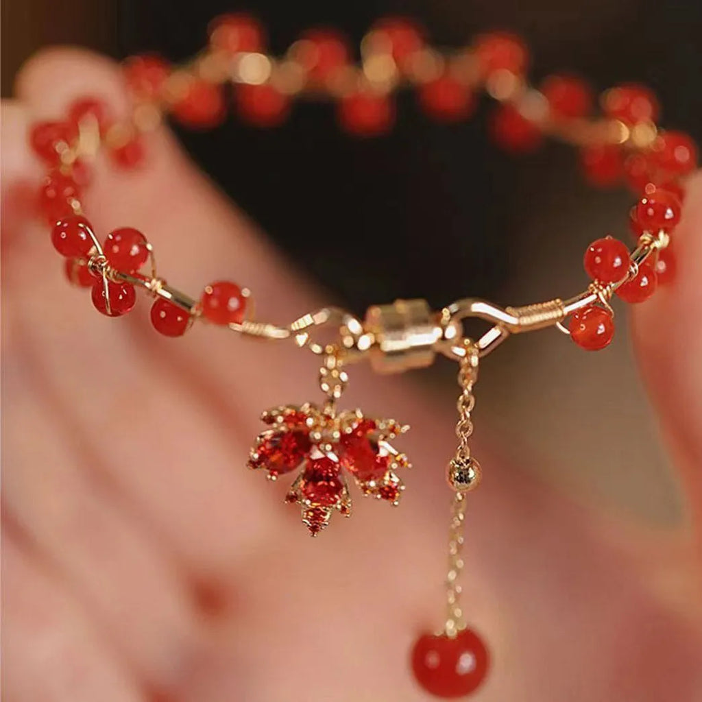 Red ginkgo leaf magnetic bracelet in alloy with electroplated finish on white background