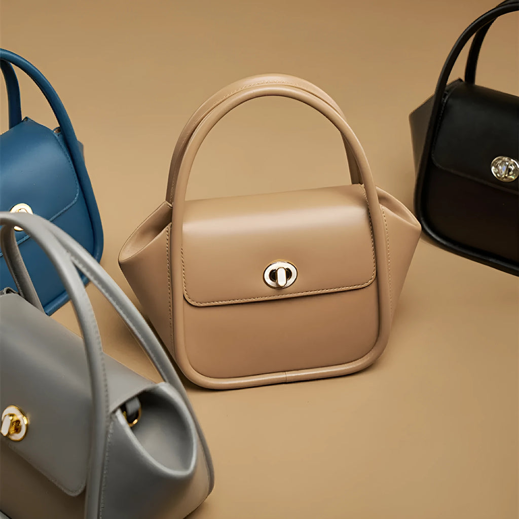 Soft wing-shaped leather cross-body tote bag in cow leather with a buckle and latch closure.