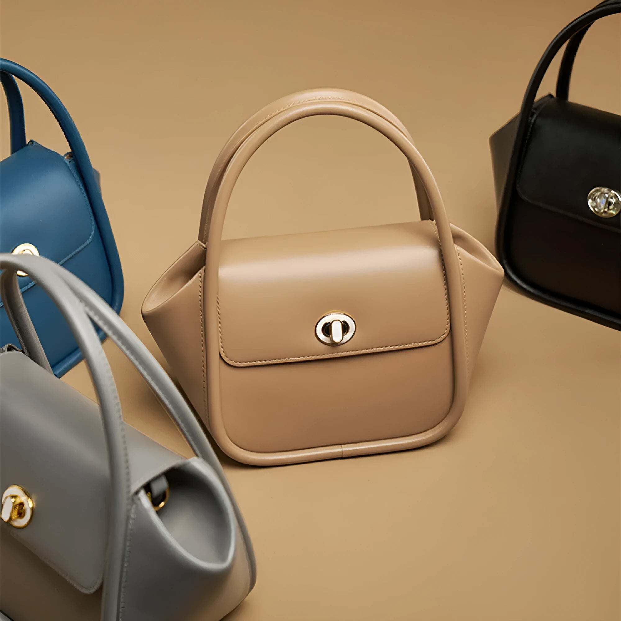 Soft wing-shaped leather cross-body tote bag in cow leather with a buckle and latch closure.