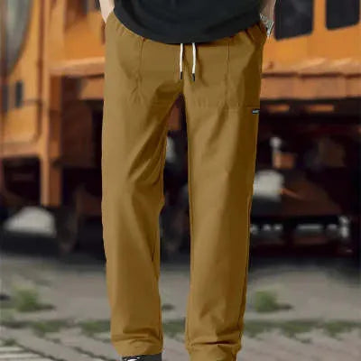 Men's polyester trousers in light grey, shown folded, for casual spring and autumn wear.