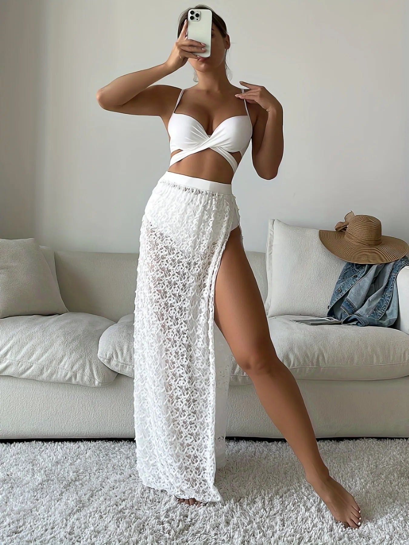 White three-piece nylon swimsuit set with gathered long skirt, top, and briefs on woman.