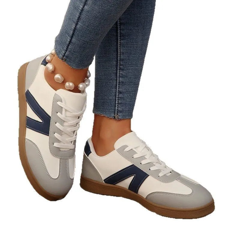 Women's blue flat German training hiking shoes with low top, front lace-up, and rubber sole