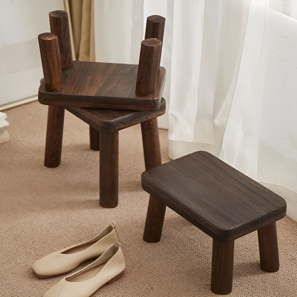 Solid wood distressed finish changing stool with bracket structure.