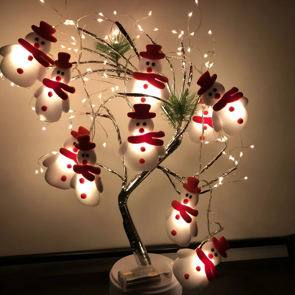 Christmas LED string lights with snowman figures, warm white glow, 1.65m length, battery powered, on a wooden mantelpiece