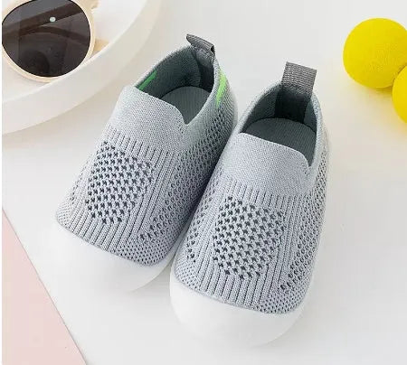 Baby soft sole non-slip walking shoes in cream yellow with fly woven cotton upper and natural rubber sole