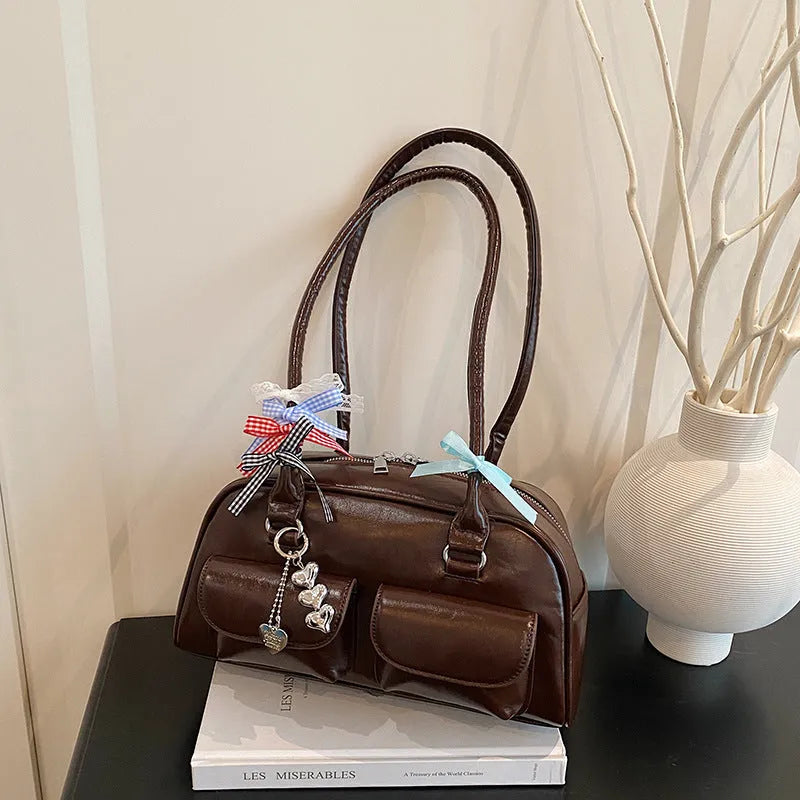 Brown PU leather women's retro pillow bag with double shoulder strap and flap closure.