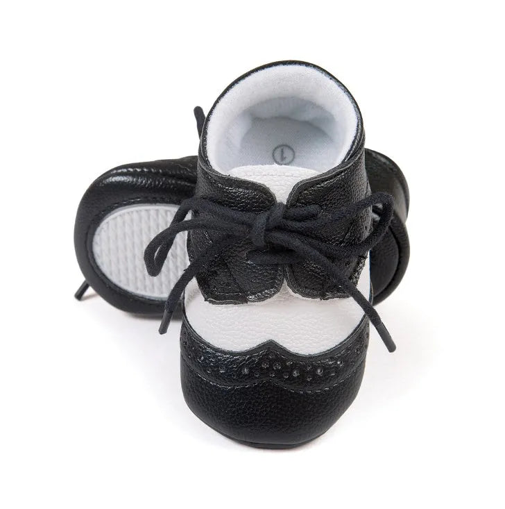 Vintage style soft-soled baby walking shoes in synthetic leather, shown in light brown colour.