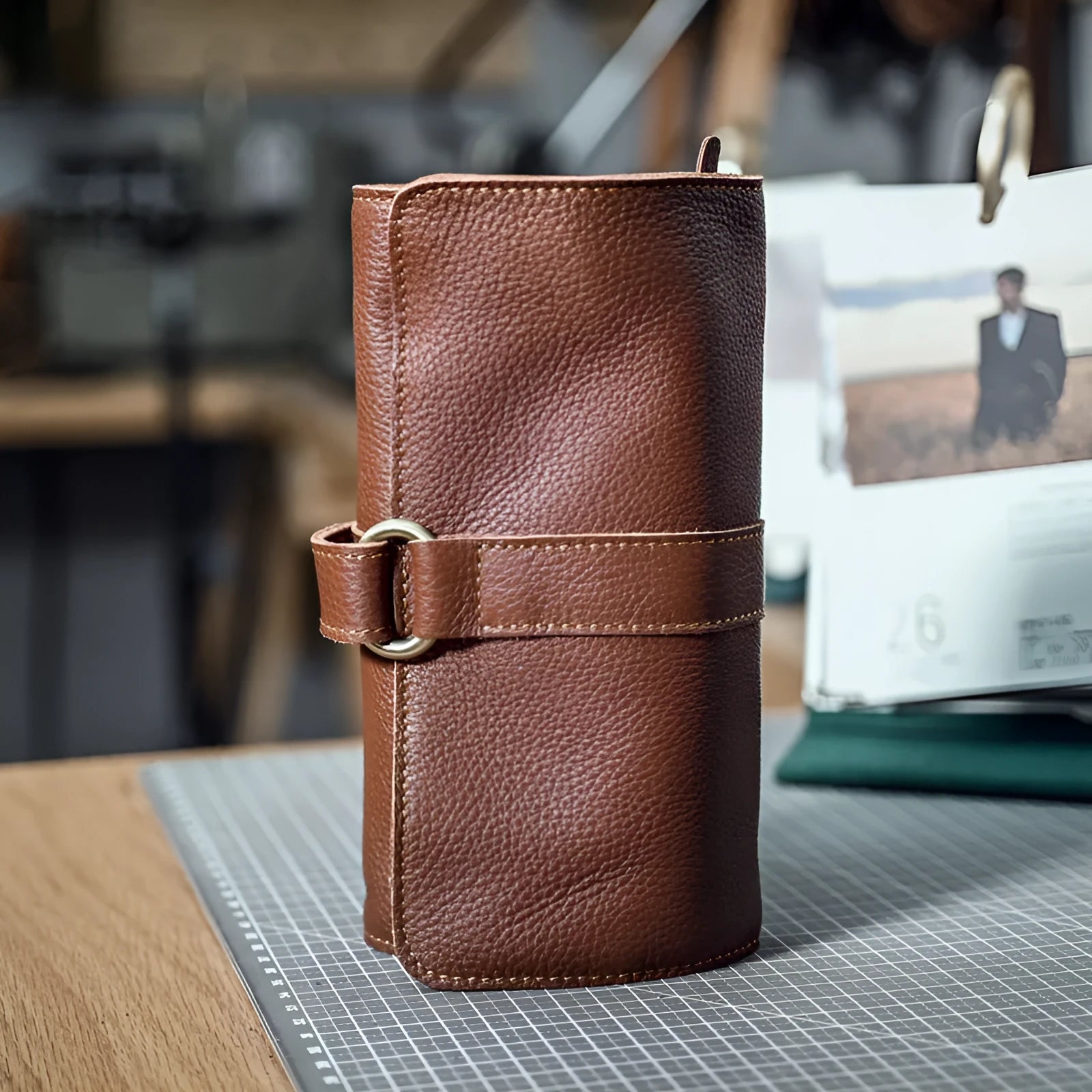 Handmade vintage style leather wallet in black, showing tape extraction closure.