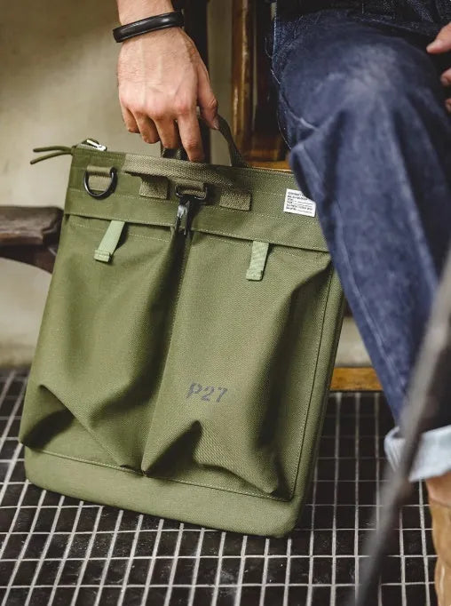 Canvas messenger bag in military green with shoulder strap and laptop compartment