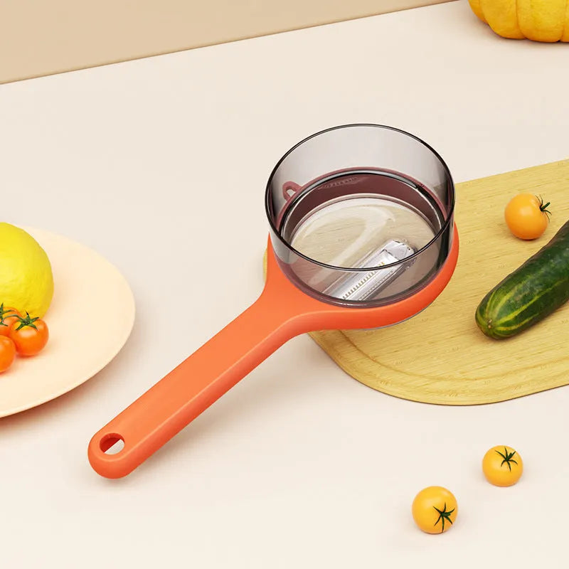 Kitchen multi-functional peeler with bucket storage in light green plastic on a clean countertop