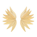 Gold and white leaf-shaped patch earrings made of alloy metal on a neutral background