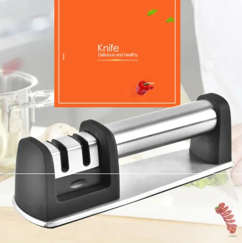New kitchen sharpener made of black ABS plastic on a surface, manual knife sharpening tool