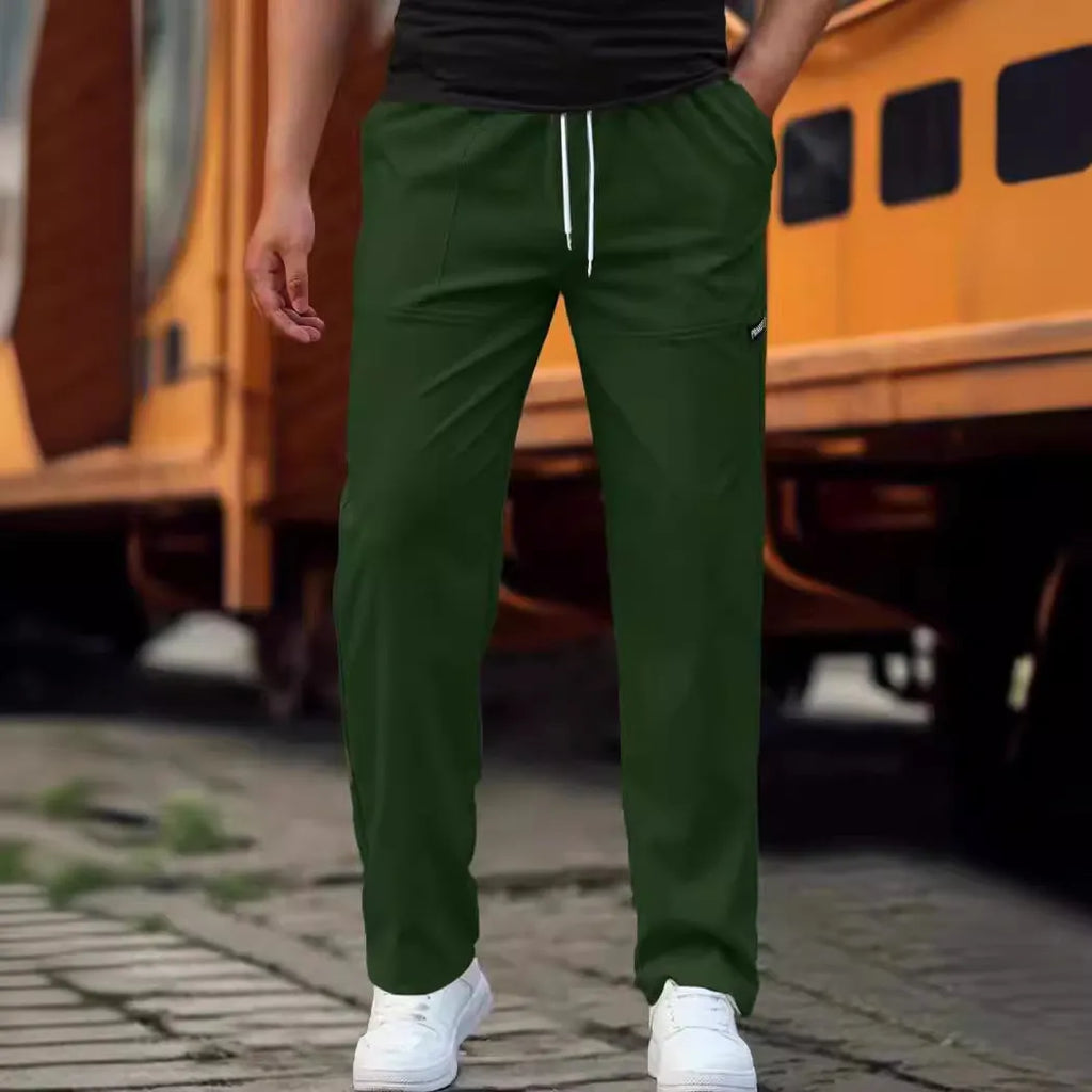 Men's polyester trousers in light grey, shown folded, for casual spring and autumn wear.