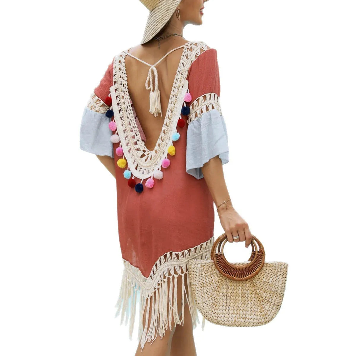 Orange floral beach overskirt with hand crochet detail and tassels on a mannequin