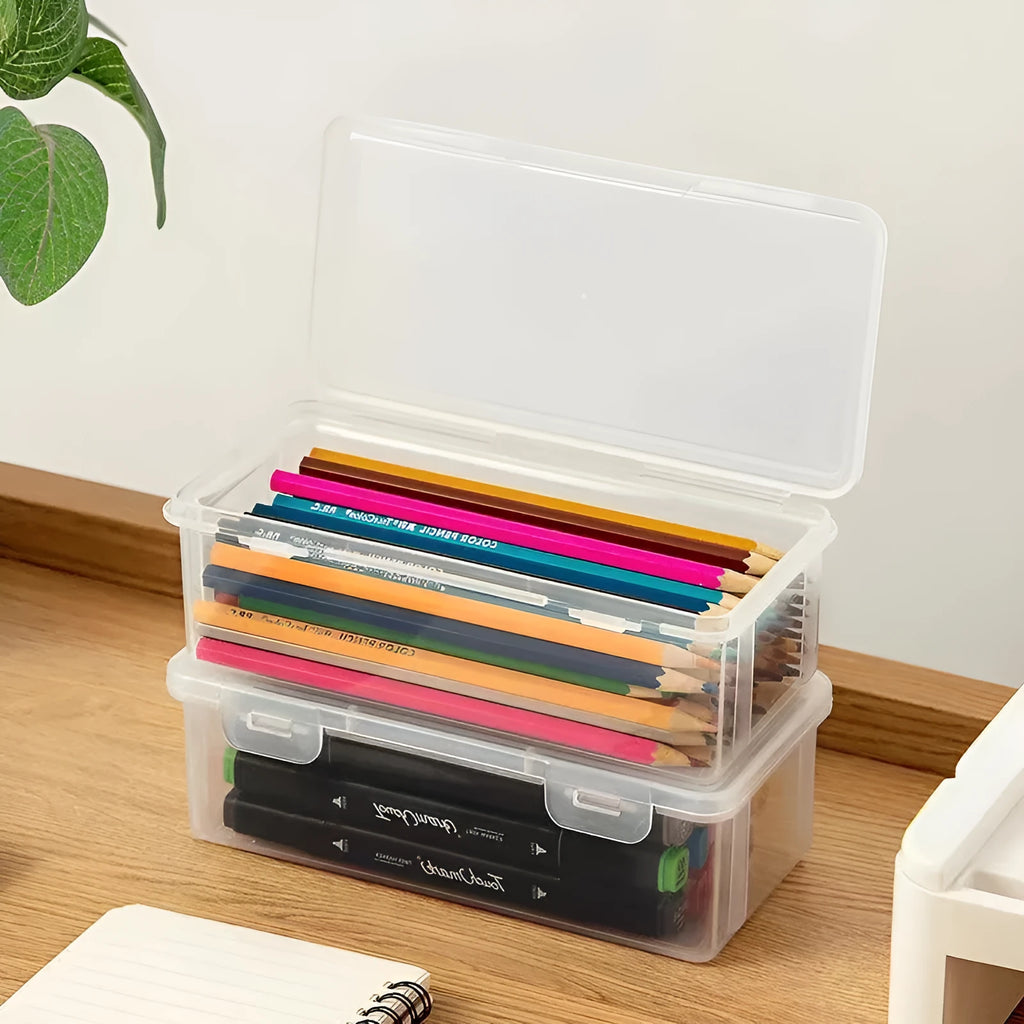 Large transparent plastic stationery storage box filled with colour pencils and crayons.