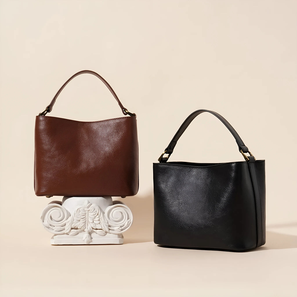 Sugar brown genuine leather women's shoulder handbag with sewing thread detailing on a white background