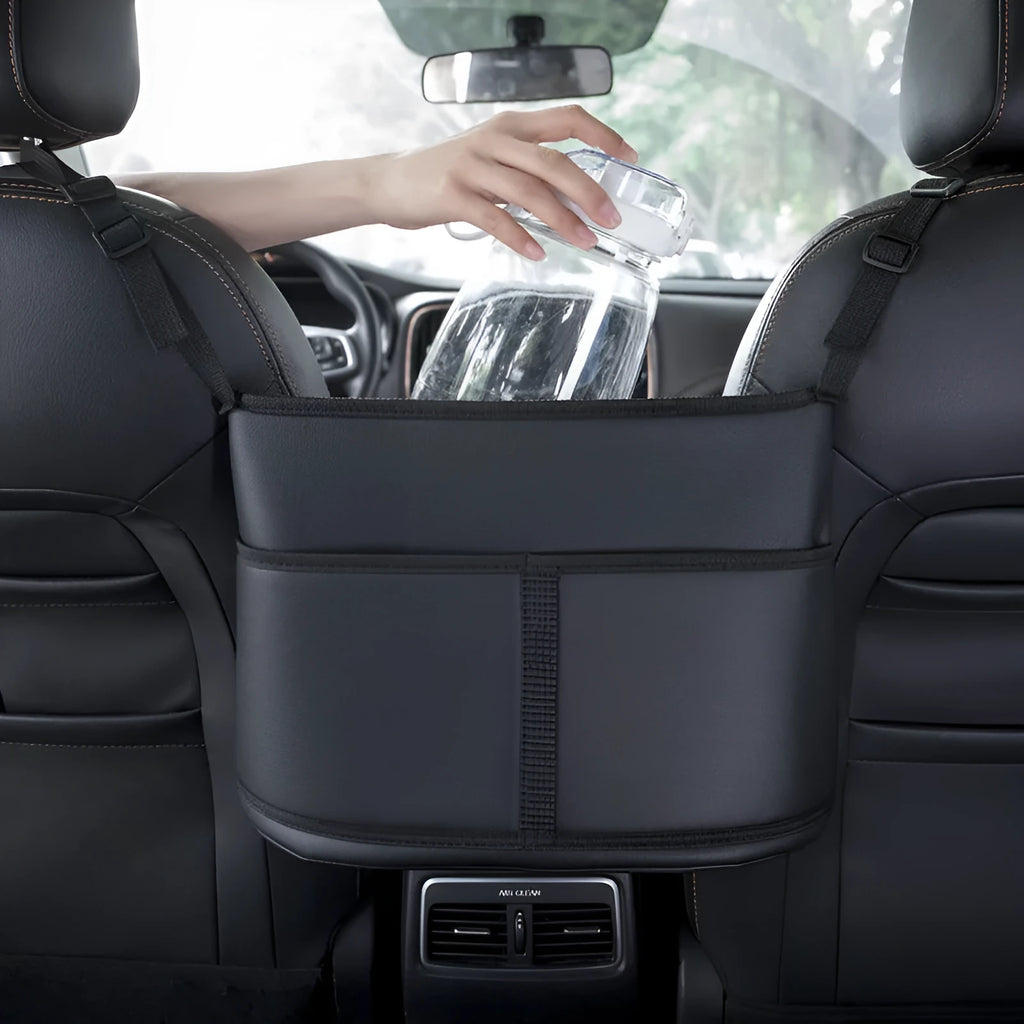 Black leather car seat gap storage bag with a carbon fibre pattern, shown in a vehicle.