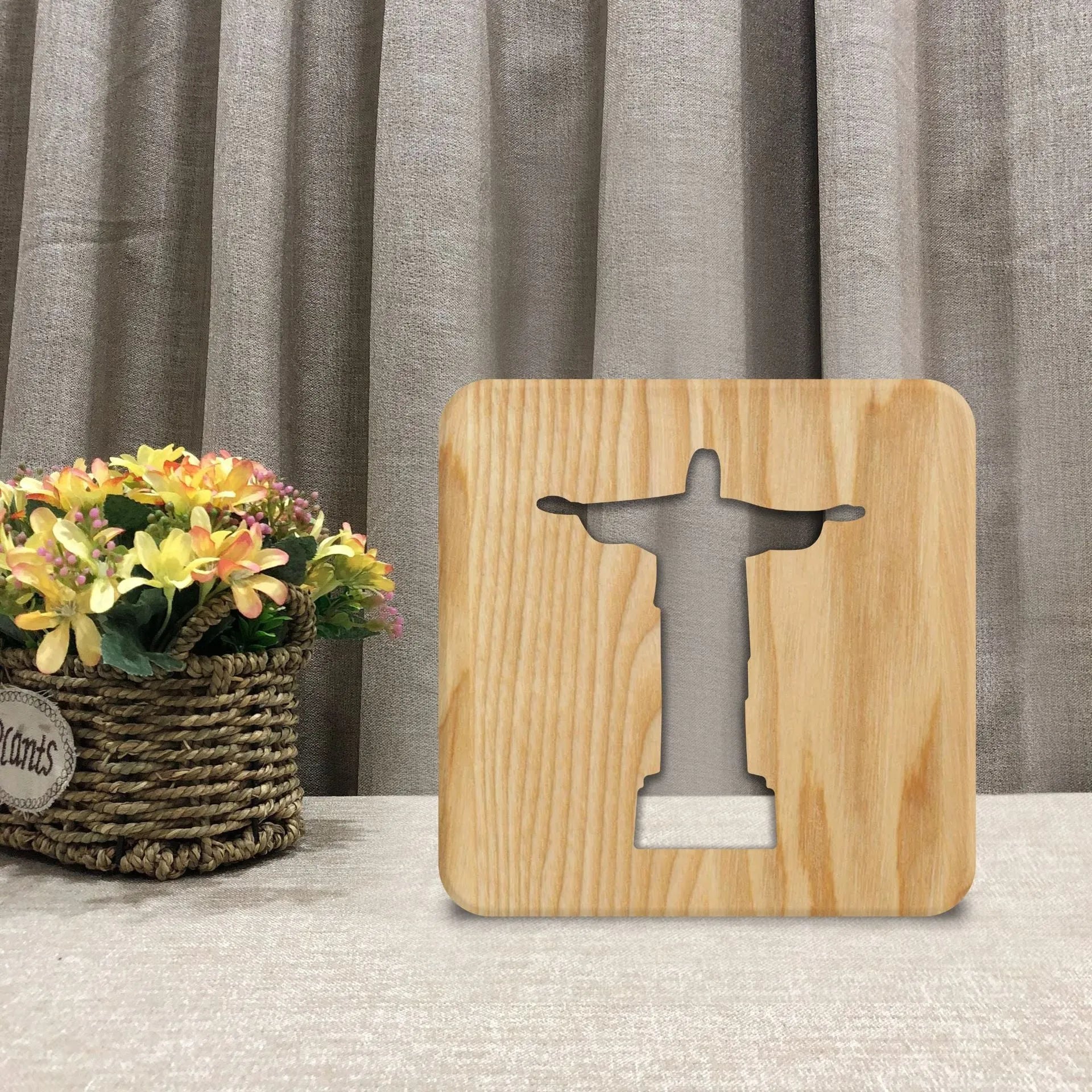 Solid wood hollow night lamp with warm white LED light, USB cable, and button switch on a wooden table