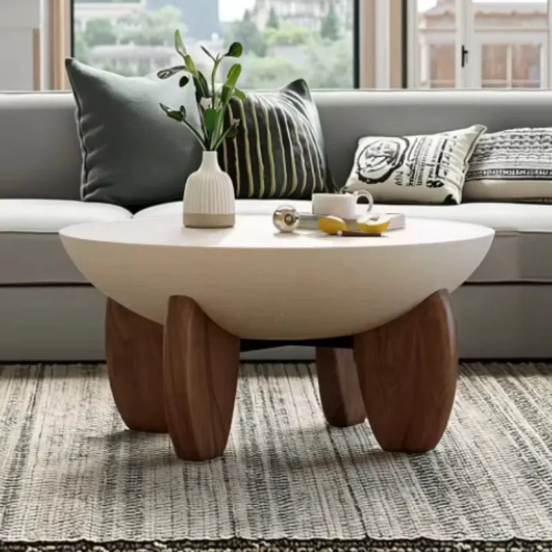 White solid wood coffee table with height adjustable legs and storage in a living room setting
