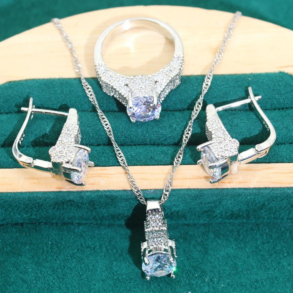 Bridal jewellery four-piece set with zircon pendants showing necklace, bracelet, earrings and ring with water wave chain design