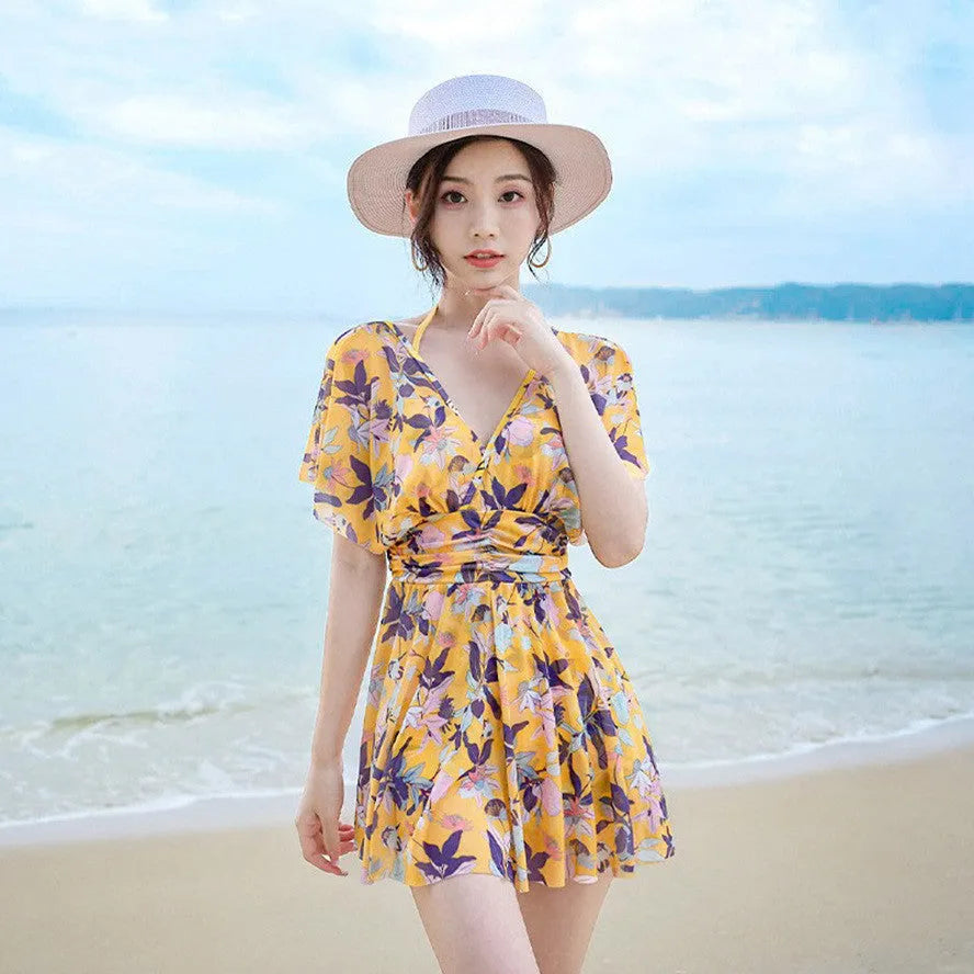 Women's yellow floral one-piece swimsuit made from polyester with full coverage design
