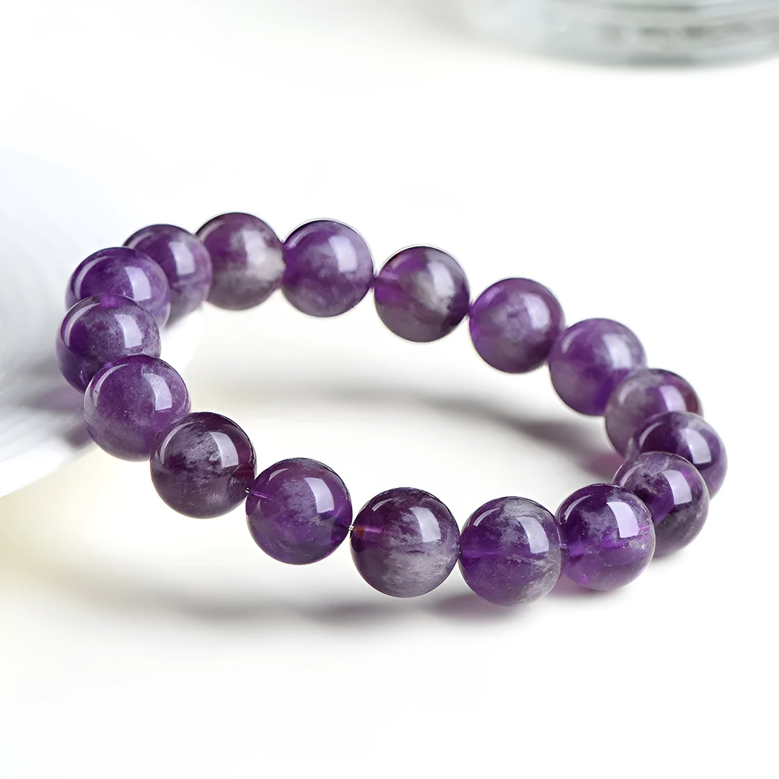 Natural feather amethyst crystal bracelet in Snow Mountain purple with scattered beads and Ruyi element.