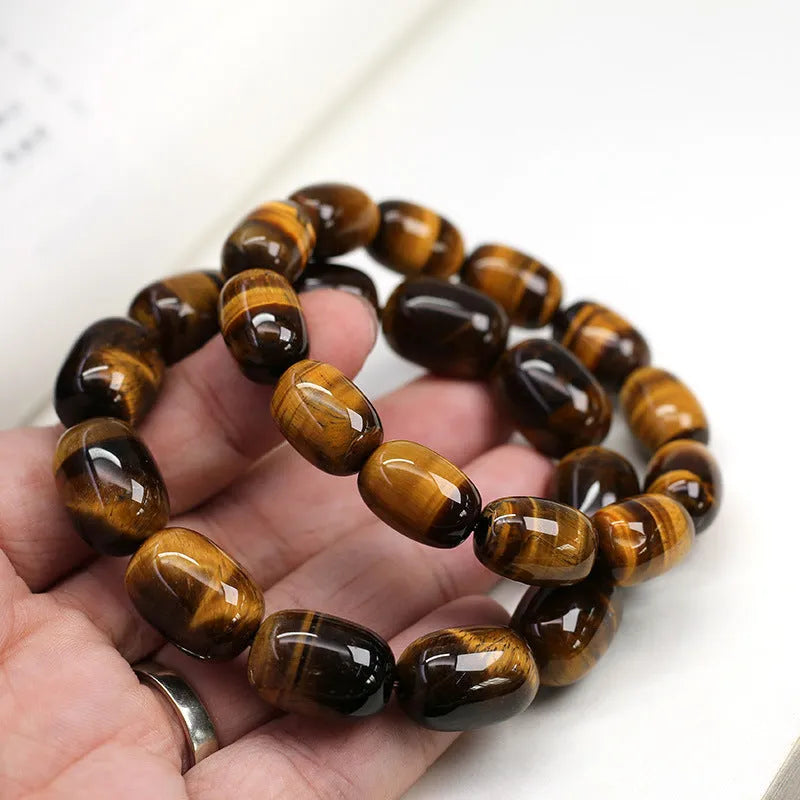 Natural yellow tigereye bracelet with cat eye sheen, 11x16mm beads, unisex constellation style on white background