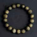 Natural crater ball obsidian bracelet with polished spherical beads showing textured meteorite-style patterns