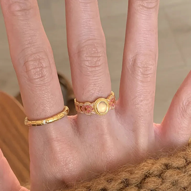 Geometric open mouth ring with pink crystal enamel detail on gold-plated copper band
